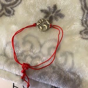 Silver world map with red band bracelet